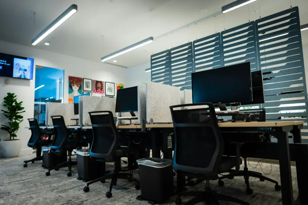 Modern empty office with multiple desks, chairs, and computers, illustrating platforms and news distribution